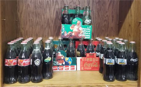 Assorted collectible Coca-Cola Bottles & Caddys