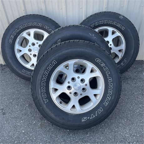 4 Yokohama Geolandar H/T-5 P245/70R16 Tires Mounted on Jeep Wheels