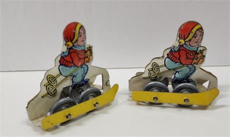 Vintage Mini Tin Plate Wheeled Skier Pair