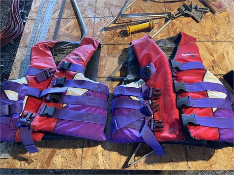 Two red and purple adult life jackets