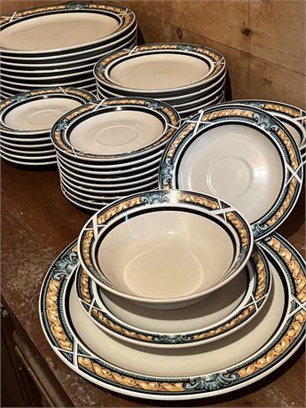 Pile of Various Plate Sizes and Four Bowls
