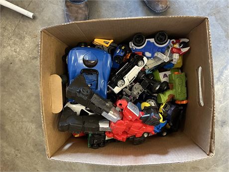 Box of toys-I see a transformer, some cars and monster trucks🛻