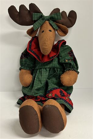 A moose doll in a little Christmas dress