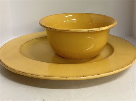 A big yellow platter and a medium sized yellow fruit bowl