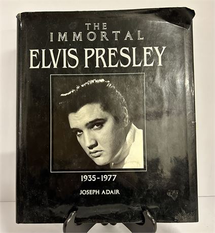 A collection of Elvis Presley books and a 1998 calendar