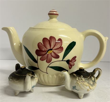 Three beautiful teapots, two smaller teapots are salt and pepper. Shakers.