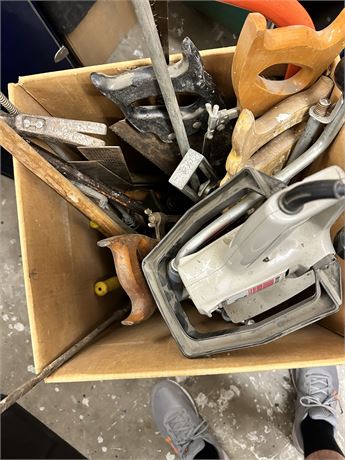 A big box full of a variety of Handsaws and other tools