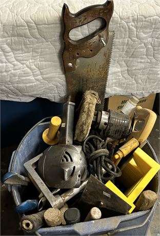 A mop bucket, full of a variety of tools.