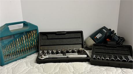 Small collection of tools with a black and decker drill and some sockets