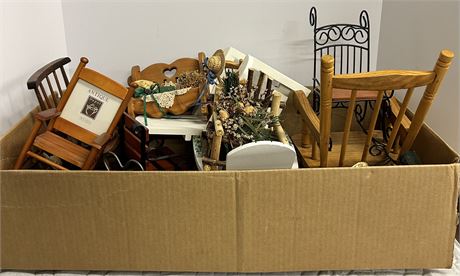 Box full of small, antique rocking chairs