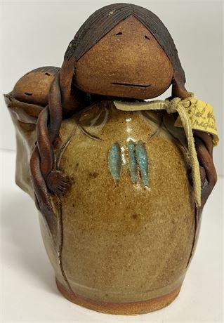 Native American girl with her child pottery