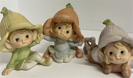 Three ceramic flower elves