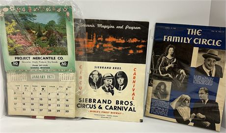 A collection of vintage magazines, photographs and a calendar