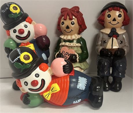 Two ceramic raggedy Ann an Andy figures and two ceramic hobo clown figures