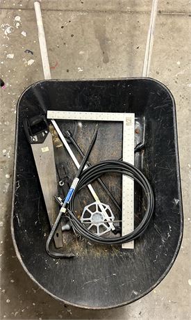 Blue hawk wheelbarrow with a mix of tools in it