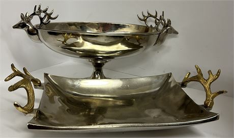 a set of silver-plated serving dishes with stag head and antler handles.