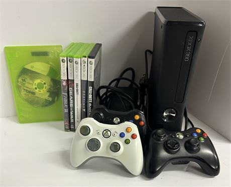 Black Xbox360 with 6 games and 3 controllers games are TOMB RAIDER