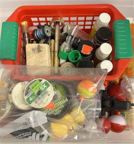 Small tote full of an assortment of fishing supplies